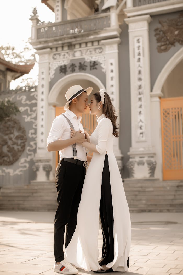 Elegant couple in traditional attire embracing during a prewedding shoot in Vietnam.